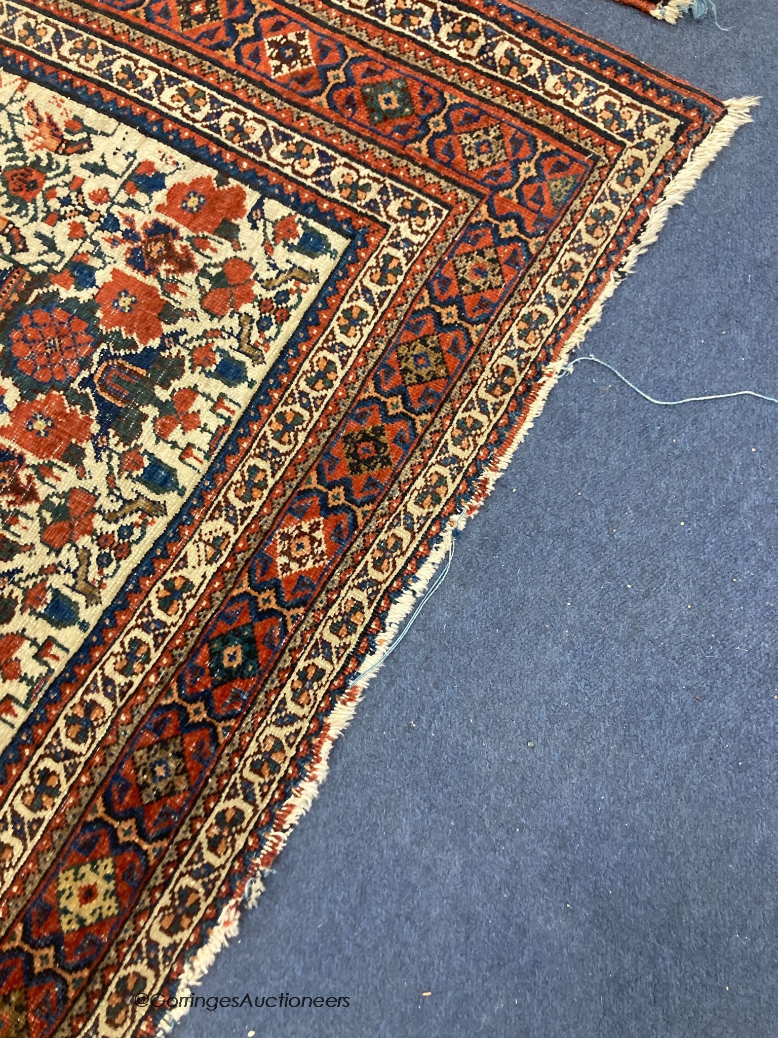 A pair of early 20th century North West Persian ivory ground rugs, woven with birds and vases of flowers, 150 x 110cm